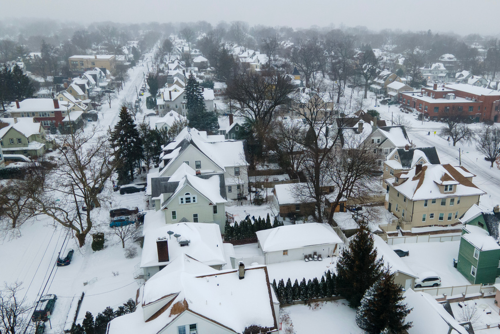 Snow covers houses in Rutherford, N.J., on Sunday, Jan. 25, 2026. (AP Photo/Ted Shaffrey)