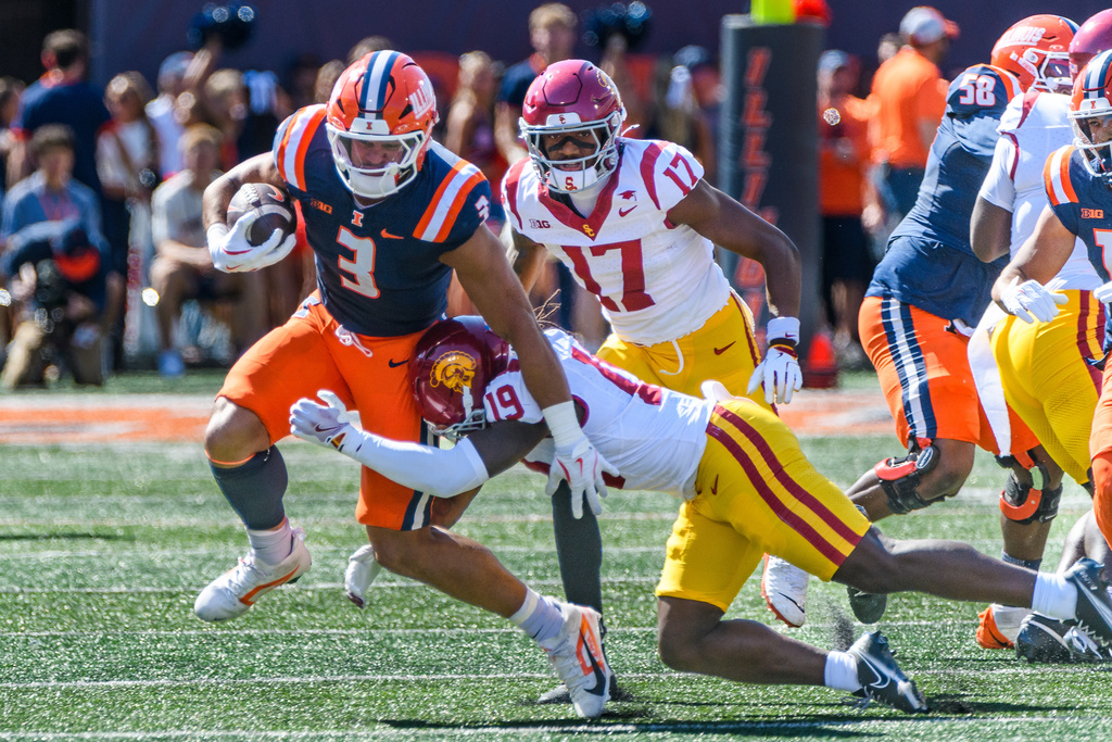 Illinois running back Kaden Feagin (3) is pursued by Southern California safety Bishop Fitzgerald (19) during the first half of an NCAA college football game Saturday, Sept. 27, 2025, in Champaign, Ill. (AP Photo/Craig Pessman)