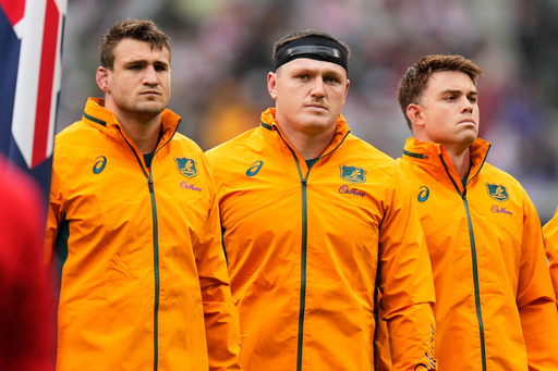 Australia's captain Nick Champion de Crespigny, left, stands with teammates Angus Bell and Andrew Kellaway, right, ahead of the rugby test between the Wallabies and Japan in Tokyo, Saturday, Oct. 25, 2025. (AP Photo/Shuji Kajiyama) Australia's captain Nick Champion de Crespigny, left, stands with teammates Angus Bell and Andrew Kellaway, right, ahead of the rugby test between the Wallabies and Japan in Tokyo, Saturday, Oct. 25, 2025. (AP Photo/Shuji Kajiyama)