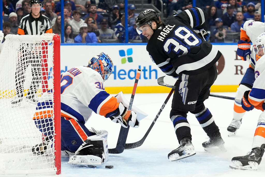 New York Islanders goaltender Ilya Sorokin (30) stops a shot by Tampa Bay Lightning left wing Brandon Hagel (38) during the second period of an NHL hockey game Saturday, Dec. 6, 2025, in Tampa, Fla. (AP Photo/Chris O'Meara)