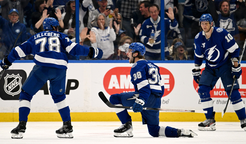 Tampa Bay Lightning defenseman Emil Lilleberg (78), left wing Brandon Hagel (38) and right wing Corey Perry (10) celebrate Hagel's goal during the third period of an NHL hockey game against the Nashville Predators, Sunday, March 29, 2026, in Tampa, Fla. (AP Photo/Jason Behnken)