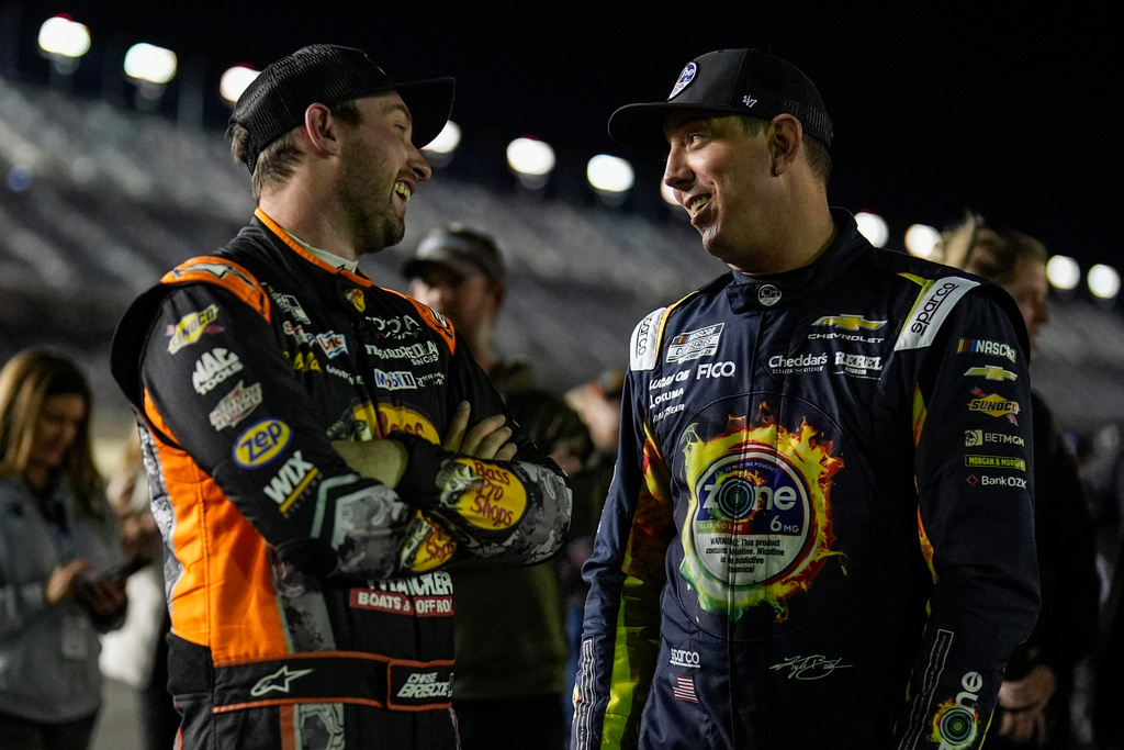 Chase Briscoe and Kyle Busch, from left, speak during NASCAR Daytona 500 qualifying, Wednesday, Feb. 11, 2026, in Daytona, Fla. (AP Photo/Mike Stewart)