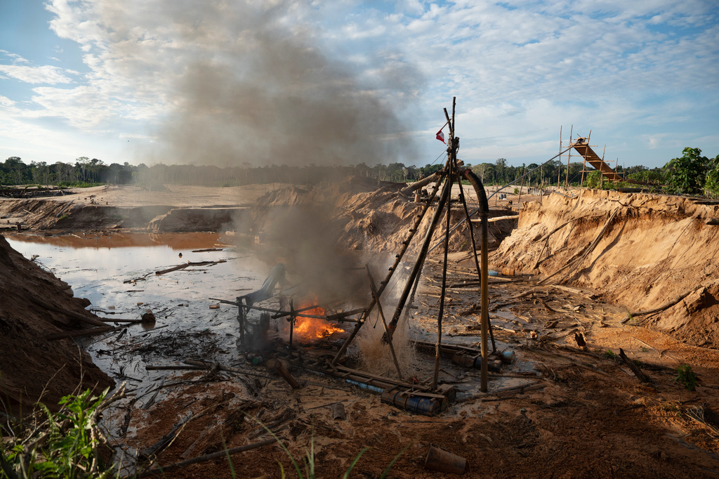 Members of the Peruvian Navy destroy a dredge used for illegal mining near the Malinowski River in the Tambopata National Reserve in Puerto Maldonado, Peru, Tuesday, Aug. 11, 2026. (AP Photo/Guadalupe Pardo)