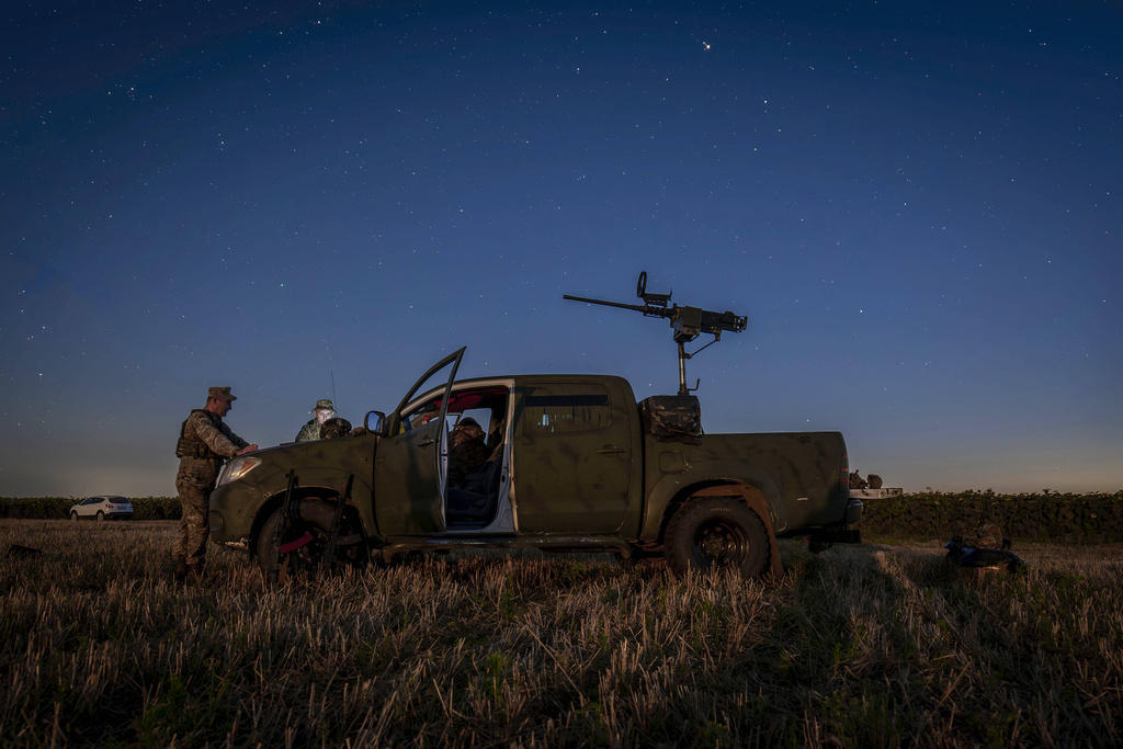 Ukrainian servicemen of the 15th Army Corps stand by an armed pickup truck during night duty in the Chernihiv region, Ukraine, late Tuesday, Aug. 12, 2025. (AP Photo/Dan Bashakov)