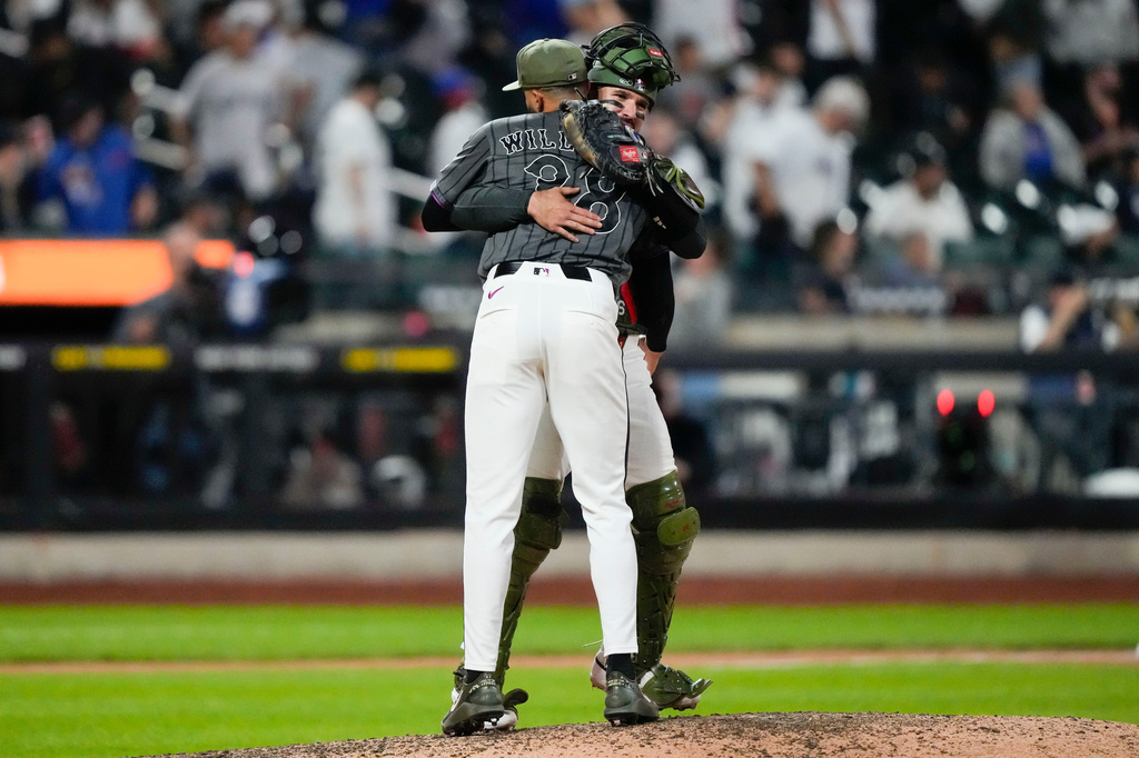 New York Mets pitcher Devin Williams and New York Mets catcher Luis Torrens embrace each other after winning a baseball game against the New York Yankees, Saturday, May 16, 2026, in New York. (AP Photo/Yuki Iwamura)