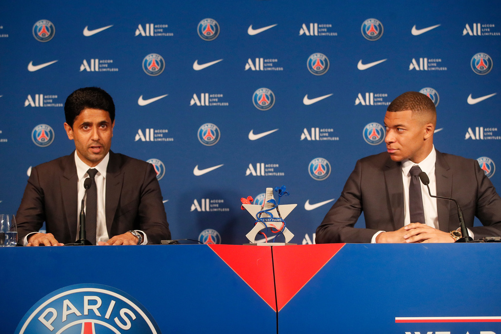 FILE - PSG striker Kylian Mbappe, right, and PSG president Nasser Al-Al-Khelaifi attend a press conference Monday, May 23, 2022 at the Paris des Princes stadium in Paris. (AP Photo/Michel Spingler, File)