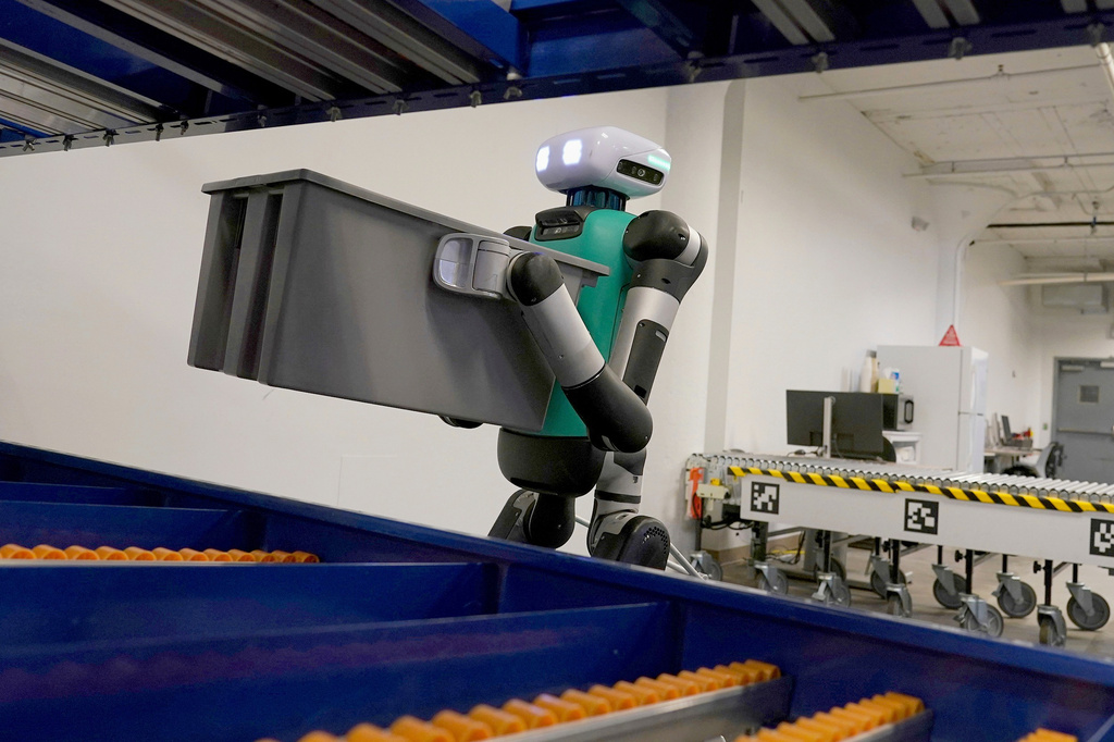 FILE - Agility Robotics' warehouse robot Digit performs maneuvers at the company's office in Pittsburgh on Aug. 16, 2023. (AP Photo/Matt Freed, File)