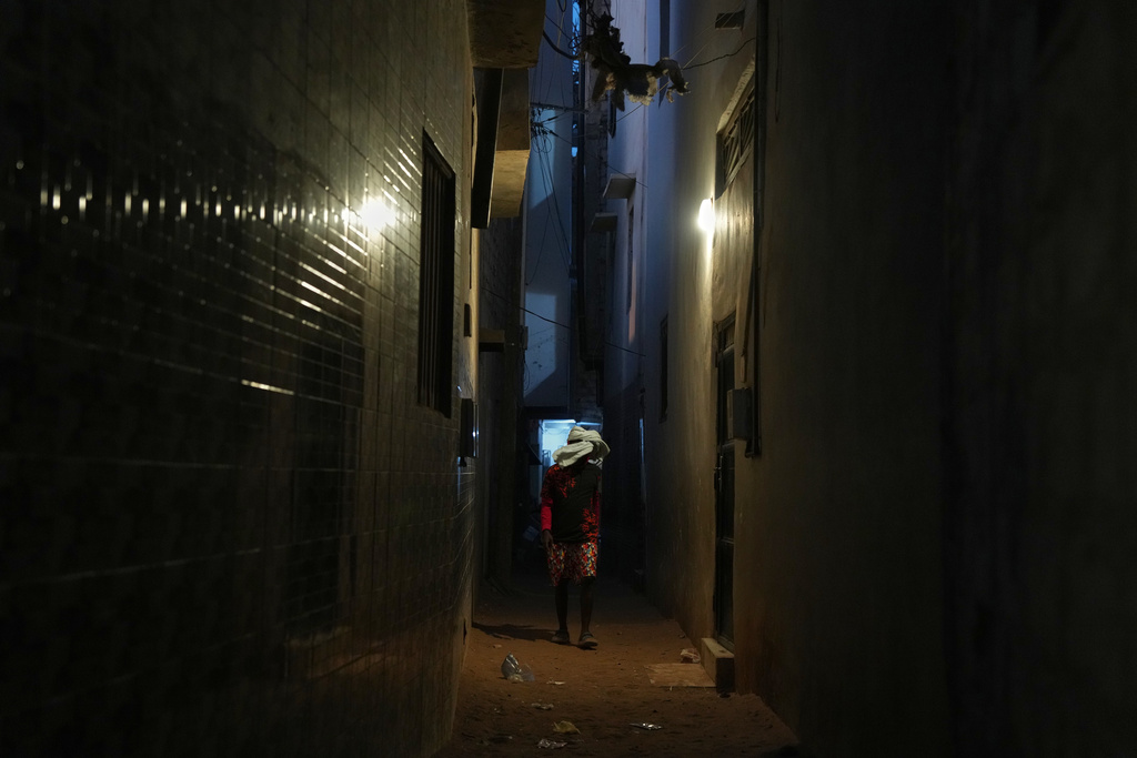 A young man disguises himself and walks through a neighbourhood in Dakar, Senegal, Thursday, March 12, 2026. (AP Photo/Misper Apawu)