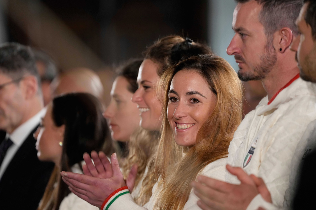Italy's Sofia Goggia, center, applauds during the hand over ceremony of the Italian flag by the Italian President Sergio Mattarella for the Milan-Cortina Winter Olympic games at the Quirinale Presidential palace, in Rome, Monday, Dec. 22, 2025. (AP Photo/Gregorio Borgia)