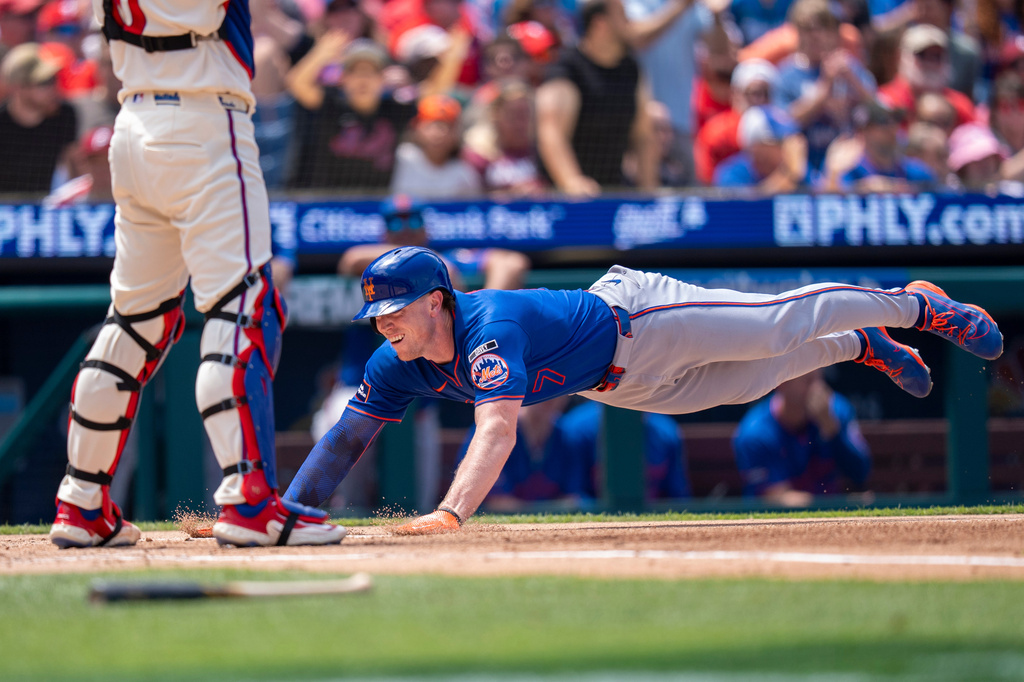 New York Mets' Brett Baty dives into home plate to score on a hit by Luis Torrens during the second inning of a baseball game against the Philadelphia Phillies, Sunday, July 19, 2026, in Philadelphia. (AP Photo/Chris Szagola) CORRECTION: Corrects to New York Mets' Brett Baty not Mets' Carson Benge.