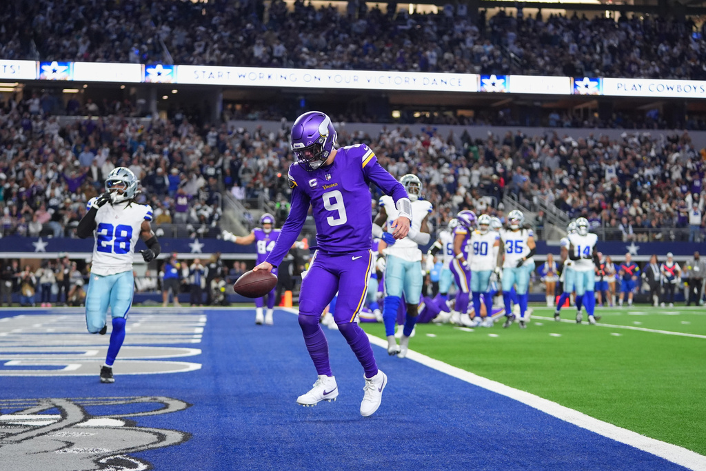 Minnesota Vikings quarterback J.J. McCarthy runs the ball into the end zone for a touchdown during the first half of an NFL football game against the Dallas Cowboys Sunday, Dec. 14, 2025, in Arlington, Texas. (AP Photo/Julio Cortez)