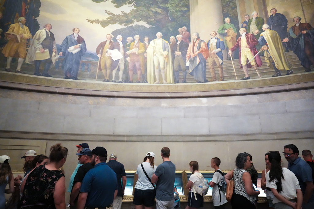 People wait to look at the original Declaration of Independence and U.S. Constitution at the National Archives Museum, Friday, July 3, 2026, in Washington. (AP Photo/Julia Demaree Nikhinson)