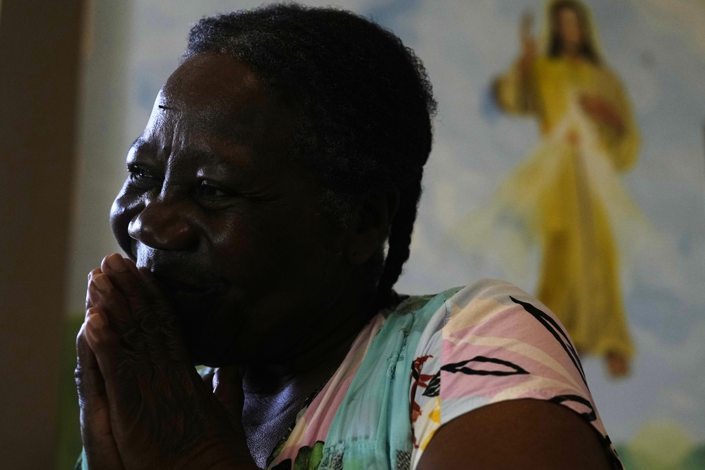 Antonia Pinedo prays inside the Catholic Church of Mururata, Bolivia, Sunday, Aug. 3, 2025. (AP Photo/Juan Karita)