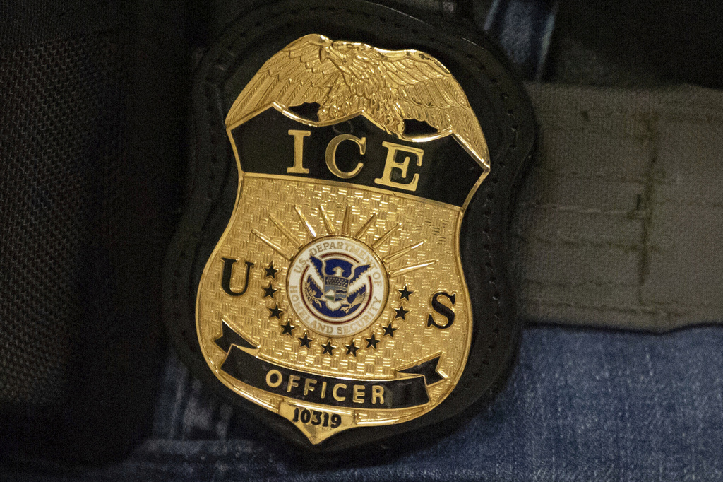 FILE - A federal agent wears an Immigration and Customs Enforcement badge in New York, June 10, 2025. (AP Photo/Yuki Iwamura, File)