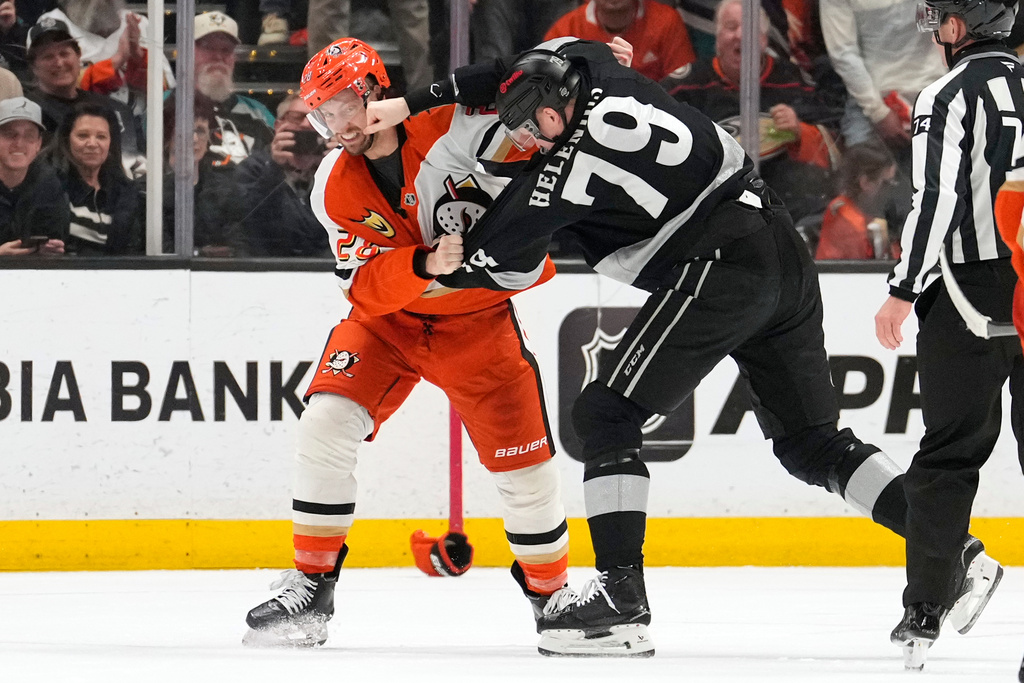 Anaheim Ducks left wing Jeffrey Viel, left, and Los Angeles Kings center Samuel Helenius fight during the first period of an NHL hockey game Saturday, Jan. 17, 2026, in Anaheim, Calif. (AP Photo/Mark J. Terrill)