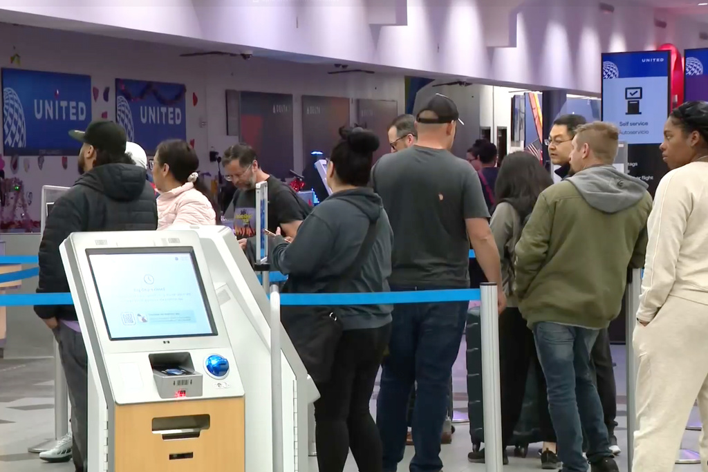 Passengers wait in line at the El Paso International Airport after all flights were grounded on Wednesday, Feb. 11, 2026. (KFOX via AP)