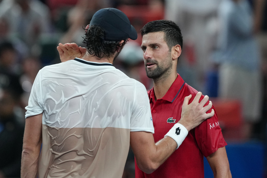 Valentin Vacherot of Monaco, left, is greeted by Novak Djokovic of Serbia after the former won in their men's singles semifinal match of the Shanghai Masters tennis tournament at Qizhong Forest Sports City Tennis Center, in Shanghai, China, Saturday, Oct. 11, 2025. (AP Photo/Andy Wong)