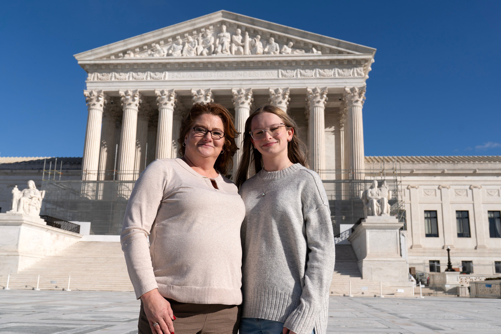 Heather Jackson, left, and Becky Pepper-Jackson pose for a photograph outside of the U.S. Supreme Court in Washington, Sunday, Jan. 11, 2026. (AP Photo/Jose Luis Magana)