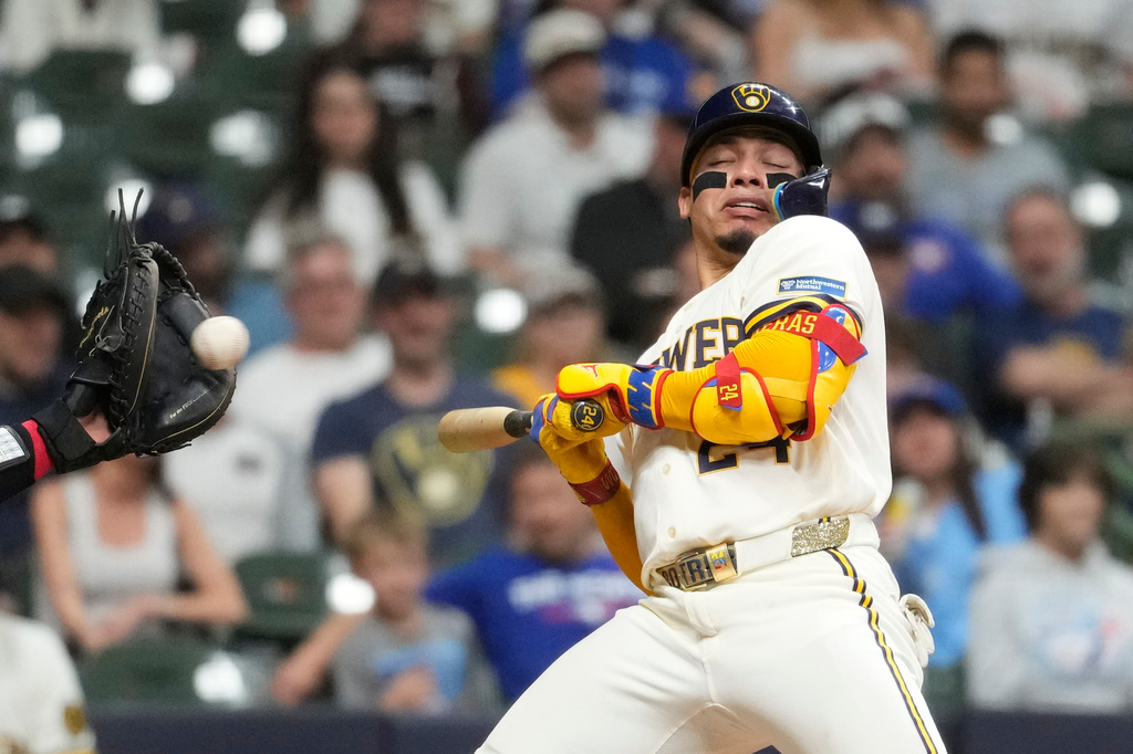 Milwaukee Brewers' William Contreras ducks to avoid being hit by a pitch during the seventh inning of a baseball game against the Toronto Blue Jays, Tuesday, April 14, 2026, in Milwaukee. (AP Photo/Aaron Gash)