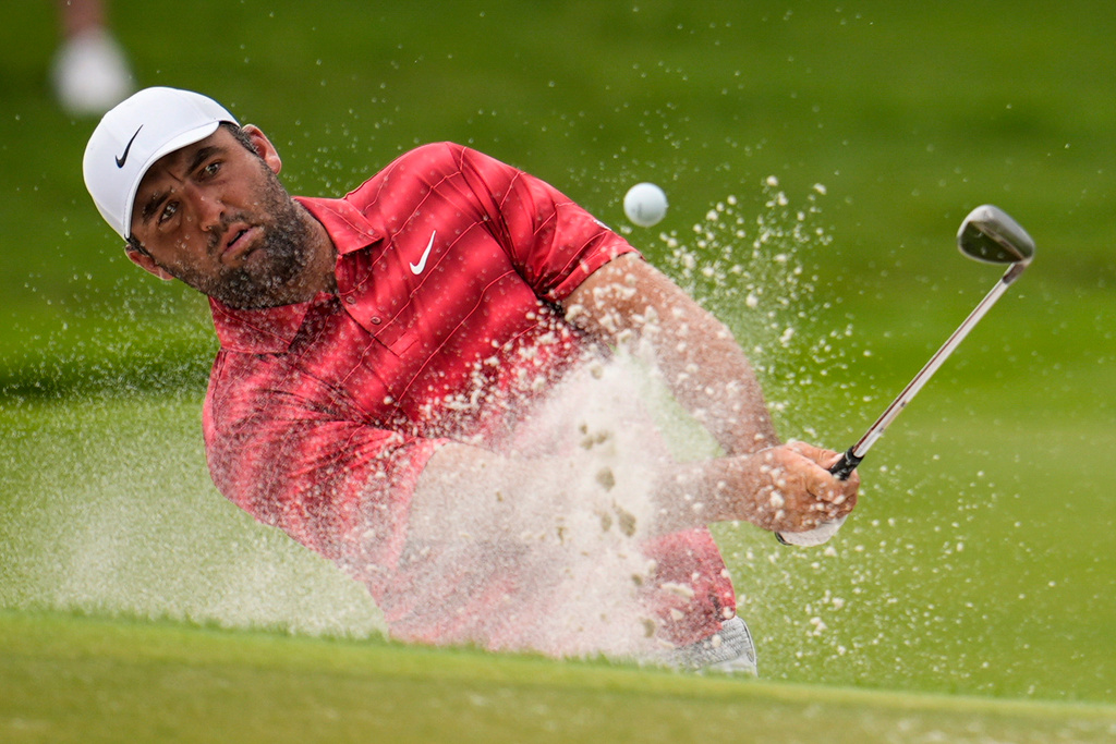 Scottie Scheffler hits from a bunker to the first green during the third round of the PGA Tour Championship golf tournament, Saturday, Aug 29, 2026, in Atlanta.(AP Photo/Mike Stewart)