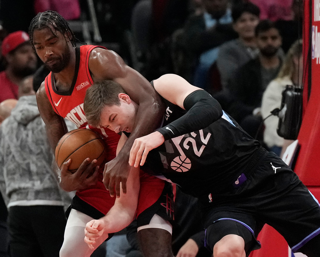 Houston Rockets forward Tari Eason, left, grabs a rebound against Utah Jazz forward Kyle Filipowski (22) during the first half of an NBA basketball game, Monday, Feb. 23, 2026, in Houston. (AP Photo/Karen Warren)