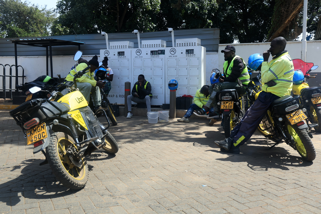 Riders wait near a motorcycle battery charging station in Nairobi, Kenya, Thursday, Jan. 29, 2026. (AP Photo/Andrew Kasuku)