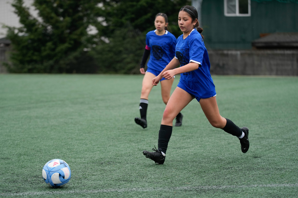 Valeria Hernandez, right, runs during a soccer tournament for immigrant and refugee girls on Sunday, March 29, 2026, in Portland, Ore. (AP Photo/Jenny Kane)