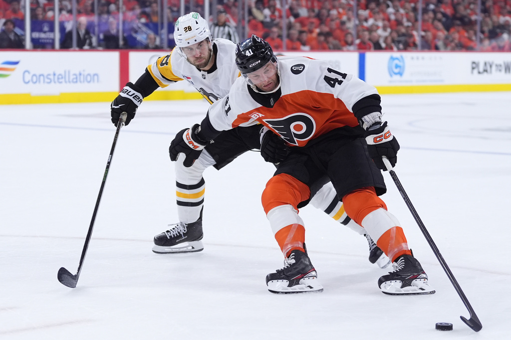 Philadelphia Flyers' Luke Glendening, right, tries to keep the puck away from Pittsburgh Penguins' Parker Wotherspoon during the second period of Game 3 in the first round of the NHL Stanley Cup hockey playoffs Wednesday, April 22, 2026, in Philadelphia. (AP Photo/Matt Slocum)