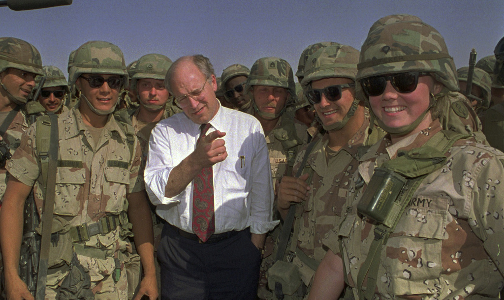 FILE - Defense Secretary Dick Cheney poses with some of the U.S. Army troops stationed in southern Iraq in this May 7, 1991 file photo. (AP Photo/Bill Haber, File)