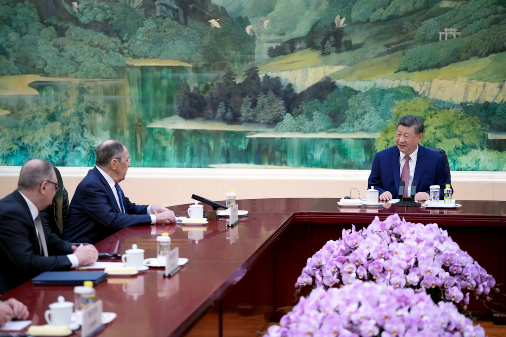Russia's Foreign Minister Sergey Lavrov, second left, and China's President Xi Jinping, right, hold a talk at the Great Hall of the People in Beijing, China Wednesday, April 15, 2026. (Iori Sagisawa/Pool Photo via AP)
