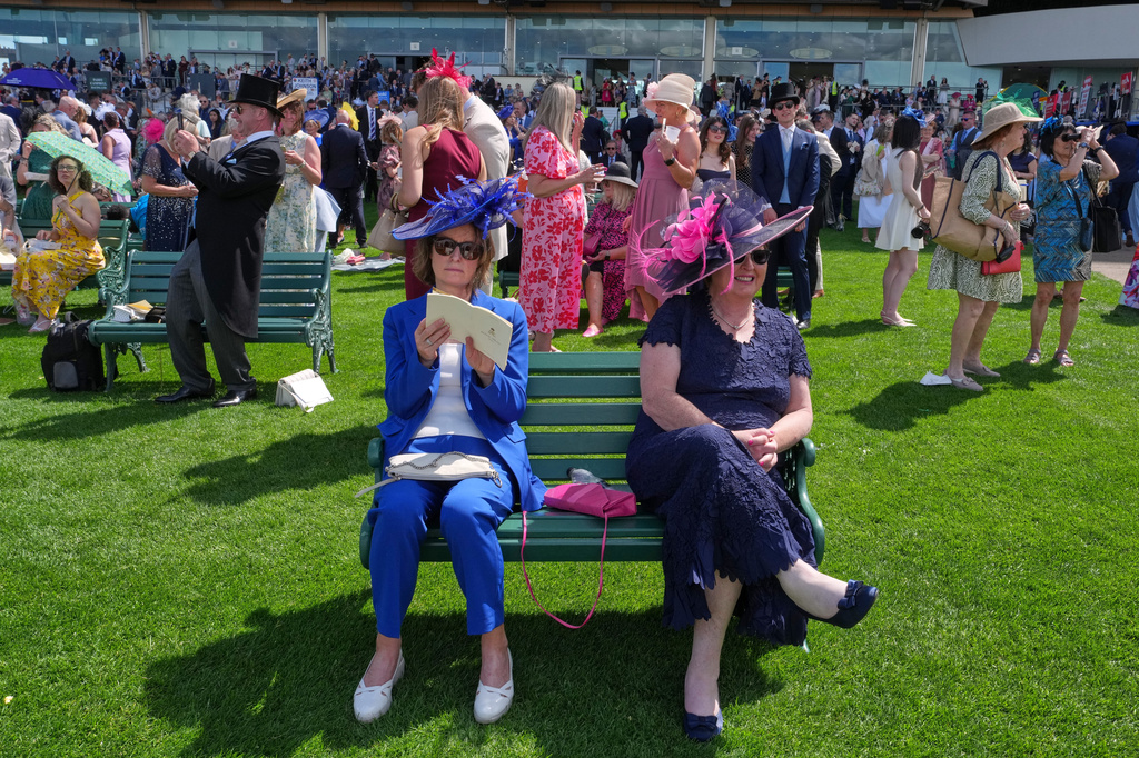Racegoers take a break on the first day of the Royal Ascot horse race meeting in Ascot, England, Tuesday, June 16, 2026.(AP Photo/Kin Cheung)