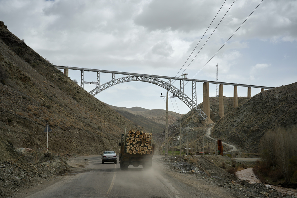 A truck loaded with logs and other vehicles drive along a road toward Tehran near the Turkish border on the outskirts of Razi, northwestern Iran, Saturday, April 4, 2026. (AP Photo/Francisco Seco)