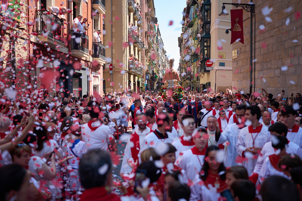 Revelers attend a procession during the San Fermín festival in Pamplona, northern Spain, Tuesday, July 7, 2026. (AP Photo/Miguel Oses)