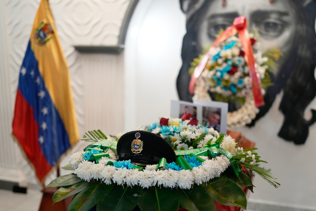 A military cap rests on the coffin of Venezuelan soldier Cesar Garcia, who was killed in a U.S. raid that captured Venezuelan President Nicolas Maduro, during his wake in Caracas, Venezuela, Wednesday, Jan. 7, 2026. (AP Photo/Matias Delacroix)