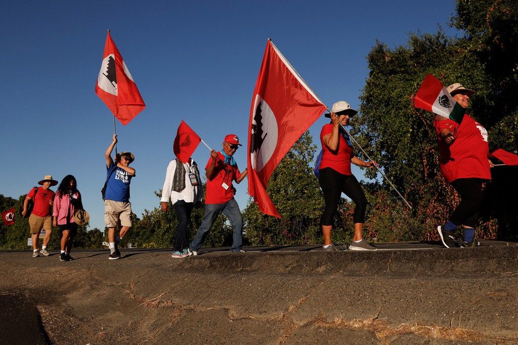 FILE - United Farm Workers members march along River Road from Walnut Grove, Calif. to Elk Grove, Calif. Wednesday, Aug. 24, 2022. (Jessica Christian /San Francisco Chronicle via AP)
