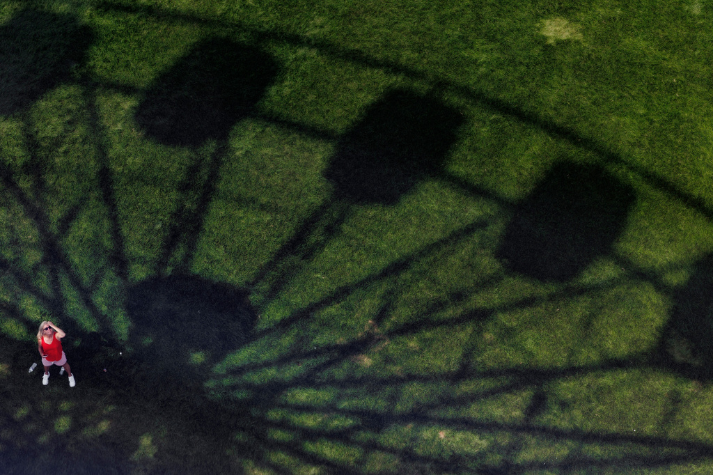 Robbin Sorrell stands in the shadow of a ferris wheel at the Great American State Fair on the National Mall, Thursday, July 2, 2026, in Washington. (AP Photo/Tom Brenner)