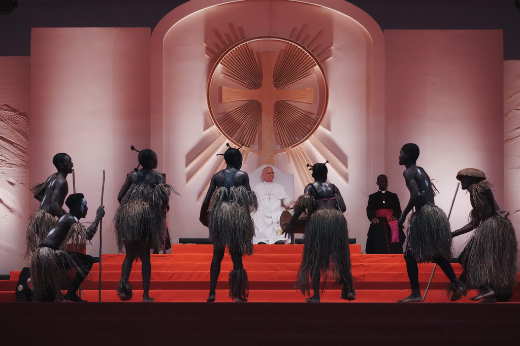 Faithful wearing traditional costumes perform for Pope Leo XIV during his meeting with young people and families at the stadium, in Bata, Equatorial Guinea, Wednesday, April 22, 2026. (AP Photo/Andrew Medichini)
