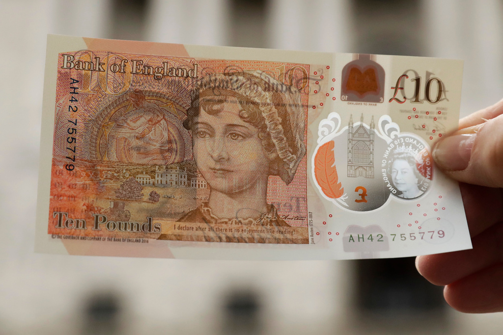 FILE - One of the new British 10 pound notes is posed for photographs outside the Bank of England in the City of London, Thursday, Sept. 14, 2017. (AP Photo/Matt Dunham, file)