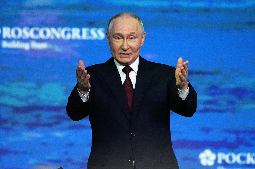 Russian President Vladimir Putin gestures as he arrives to attend a plenary session at the St. Petersburg International Economic Forum in St. Petersburg, Russia, on Friday, June 5, 2026. (AP Photo/Dmitri Lovetsky)