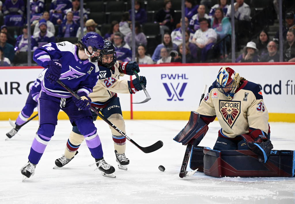 Minnesota Frost forward Abby Hustler (74) attacks the goal of Montreal Victoire goaltender Ann-Renée Desbiens (35) in the second period of a Game 4 in a PWHL hockey playoff series game, Friday, May 8, 2026, in St. Paul, Minn. (Aaron Lavinsky/Minnesota Star Tribune via AP)