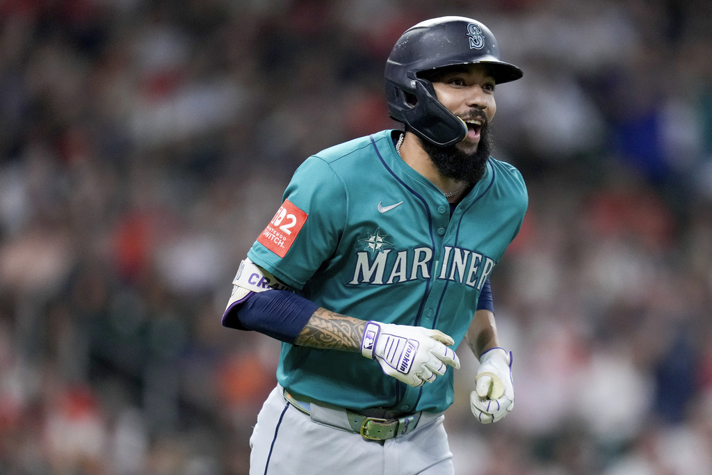 Seattle Mariners' J.P. Crawford rounds the bases after hitting a grand slam against the Houston Astros during the second inning of a baseball game Sunday, Sept. 21, 2025, in Houston. (AP Photo/Eric Christian Smith)