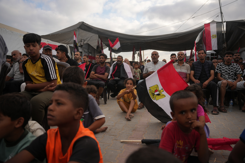 Palestinians watch a live broadcast of the World Cup soccer match between Egypt and Iran on a screen in Nuseirat, central Gaza Strip, Saturday, June 27, 2026. (AP Photo/Abdel Kareem Hana)