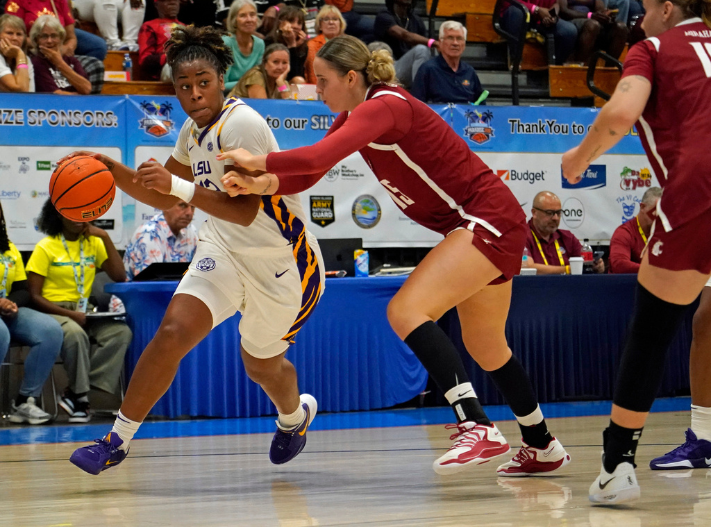LSU guard Mikaylah Williams, left, drives against Washington State guard Keandra Koorits during the first quarter of their Reef Division championship game at the Paradise Jam NCAA college basketball tournament in St. Thomas, U.S. Virgin Islands, Saturday, Nov. 29, 2025. (Bill Kiser/Virgin Islands Daily News via AP)