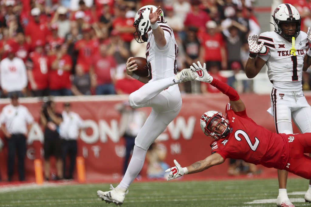 Texas Tech quarterback Will Hammond runs against Utah cornerback Smith Snowden during the second half of an NCAA college football game Saturday, Sept. 20, 2025, in Salt Lake City, Utah. (AP Photo/Jeffrey D. Allred)