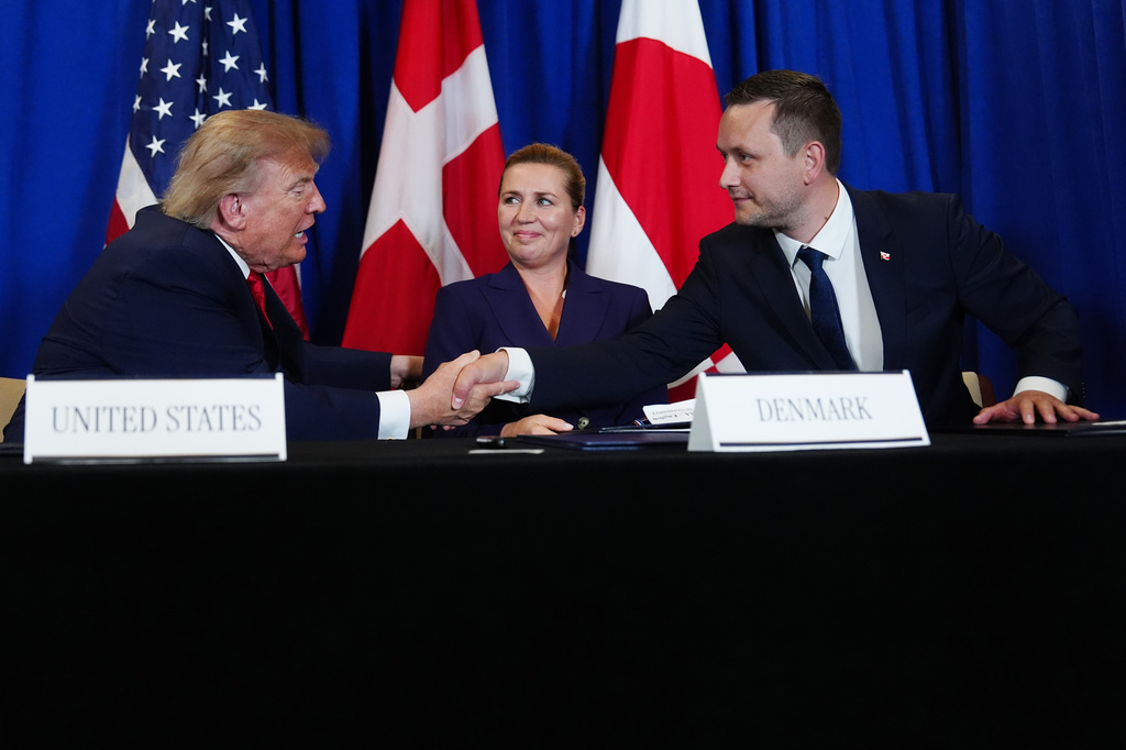 President Donald Trump shakes hands with Greenland's Prime Minister Jens-Frederik Nielsen, before signing a security agreement during the United Nations General Assembly, Tuesday, Sept. 22, 2026, at the UN headquarters, as Denmark's Prime Minister Mette Frederiksen, center, looks on. (AP Photo/Julia Demaree Nikhinson)