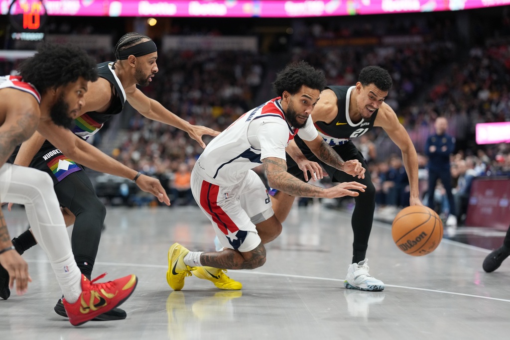 From left to right, Washington Wizards forward Marvin Bagley III, Denver Nuggets forward Zeke Nnaji, Wizards guard Justin Champagnie and Nuggets forward Spencer Jones pursue the ball in the second half of an NBA basketball game Saturday, Jan. 17, 2026, in Denver. (AP Photo/David Zalubowski)