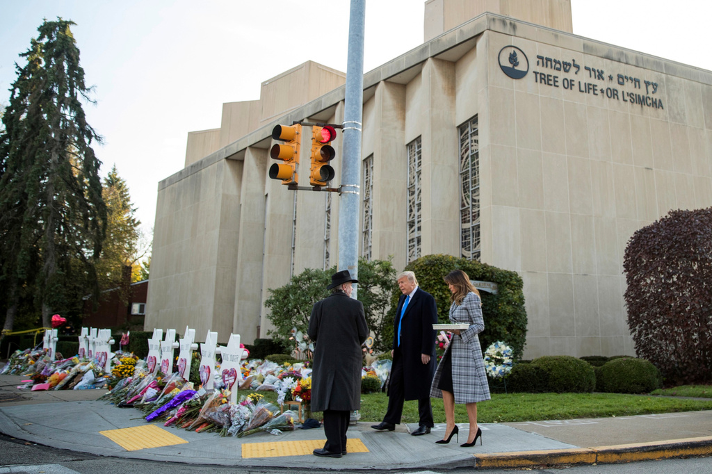 FILE - Tree of Life Rabbi Jeffrey Myers, left, walks President Donald Trump and first lady Melania Trump to a memorial outside the Tree of Life Synagogue in Pittsburgh, on Oct. 30, 2018, for those who were fatally shot days earlier. (AP Photo/Andrew Harnik, File)