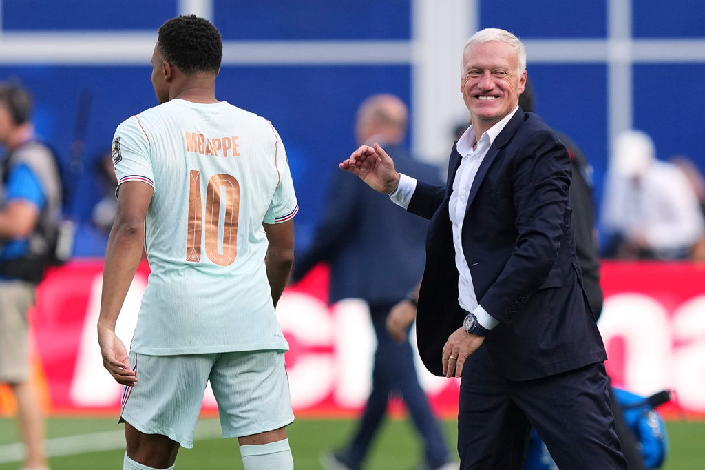 France head coach Didier Deschamps smiles after hugging France's Kylian Mbappe (10) after France defeated Morocco in the World Cup quarterfinal soccer match between France and Morocco in Foxborough, Mass., near Boston, Thursday, July 9, 2026. (AP Photo/Martin Meissner)