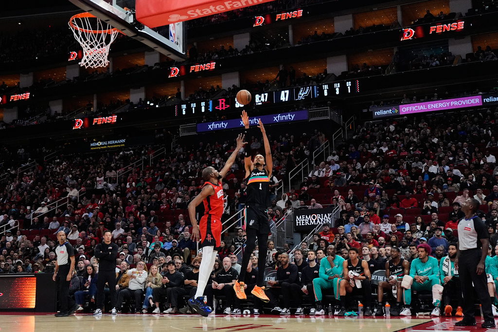 San Antonio Spurs forward Victor Wembanyama (1) shoots against Houston Rockets forward Kevin Durant (7) during the first half of an NBA basketball game in Houston, Tuesday, Jan. 20, 2026. (AP Photo/Ashley Landis)