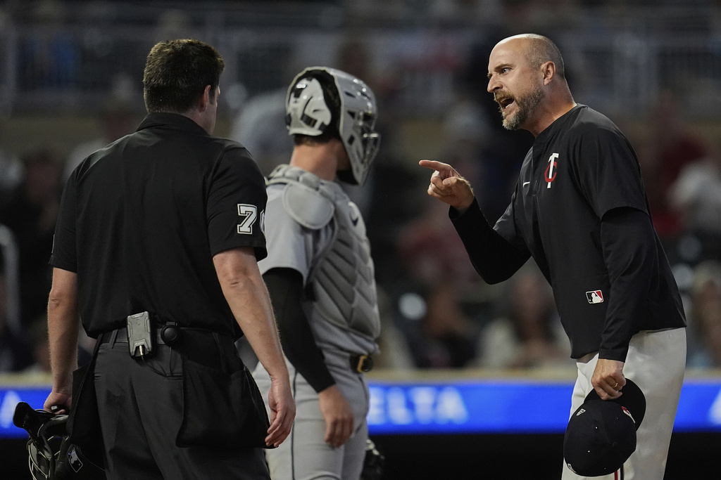Minnesota Twins manager Rocco Baldelli, right, reacts toward home umpire John Bacon, left, after being ejected during the 11th inning of a baseball game against the Detroit Tigers, Thursday, Aug. 14, 2025, in Minneapolis. (AP Photo/Abbie Parr)